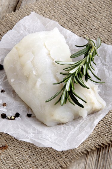 cod filled with rosemary on kitchen paper