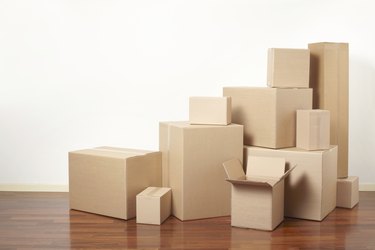 Cardboard boxes stack in apartment, moving day