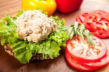 Tuna fish sandwich on multigrain bread with lettuce and tomato