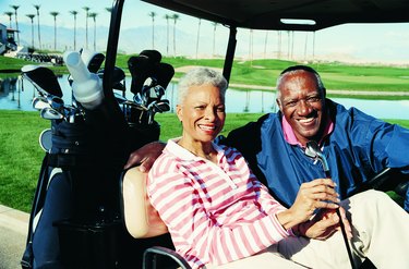 Portrait of a Senior Couple Sitting in a Golf Cart