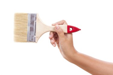 hand holding paintbrush