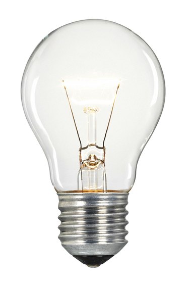 Single glowing glass light bulb