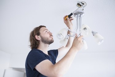 Person fixing lamp