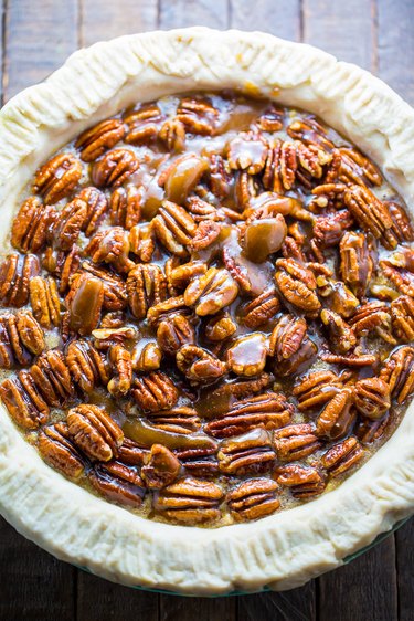 Spoon pecan halves on top of the pie and bake for 75 minutes.