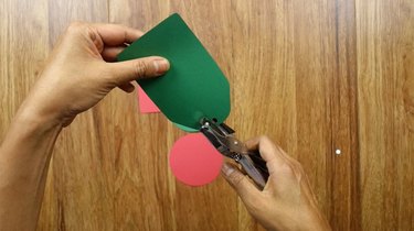 Using hole puncher to make holes in DIY Christmas tags