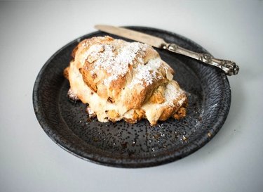Plate of almond croissant dusted with powdered sugar.