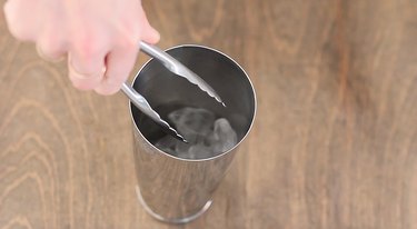 filling cocktail shaker with ice
