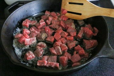 beef cooking in a skillet