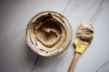Use the rubber spatula to mix the food dyes together to form a light brown color.