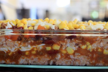 Layers of rice, meat and beans, corn and cheese.