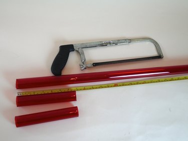 A hand saw with the lamp sleeve cut into 3 parts.