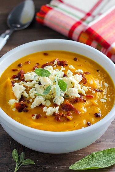 Butternut squash soup topped with bacon and cheese.