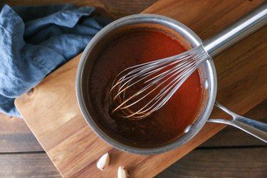 Taco sauce with a whisk in a pot