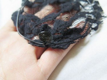Laying the wire ear on top of one cut lace piece.