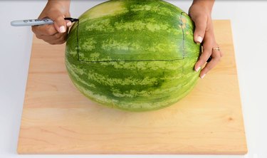 Hand drawing a trace line where you want to cut into the watermelon.