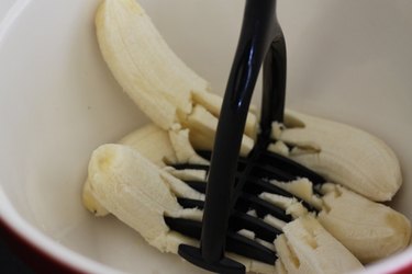 A potato masher works best but a fork would also do for very ripe bananas.