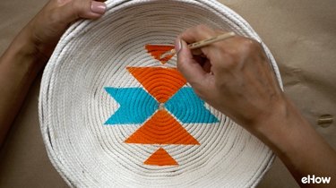 Creating faux woven effect on DIY desert-style baskets.