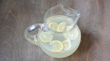 Pitcher of sparkling lemonade garnished with lemon wheels