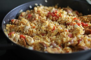Cooked paella mixture in a pan