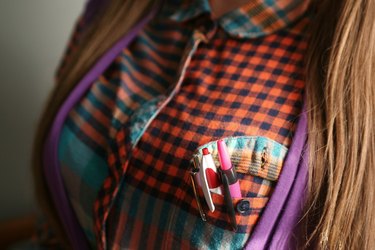 Shirt pocket protector and pens in the button-down shirt of the nerd costume