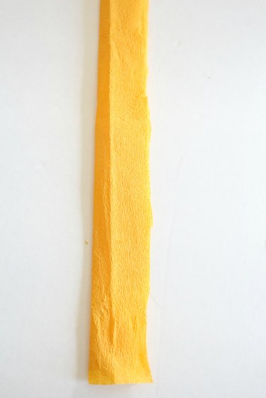 Cut a 12 inch strip of yellow crepe paper