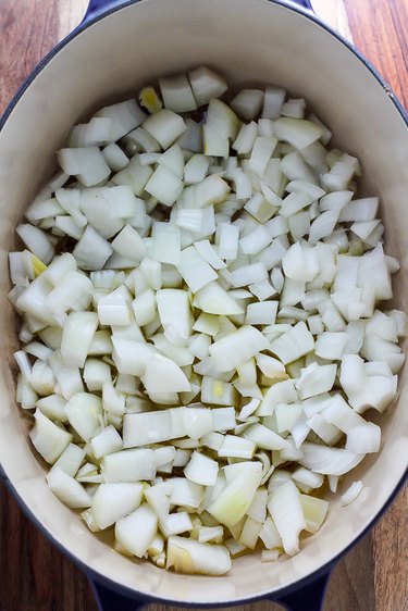 Chopped onions being sauteed in olive oil.