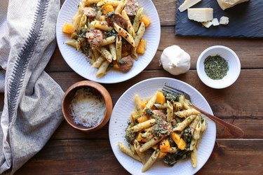 Two plates of butternut squash and sausage pasta