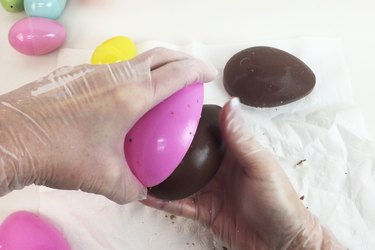 Pop the chocolate out of the plastic eggs