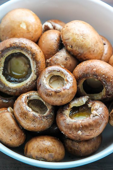 Drizzle the mushrooms with olive oil.
