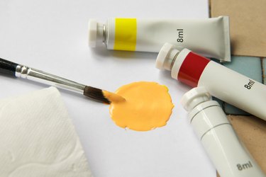A paint brush with peach paint