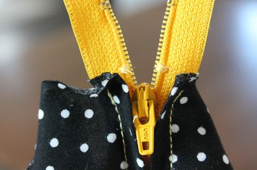 Stitch across both sides of the zipper teeth.