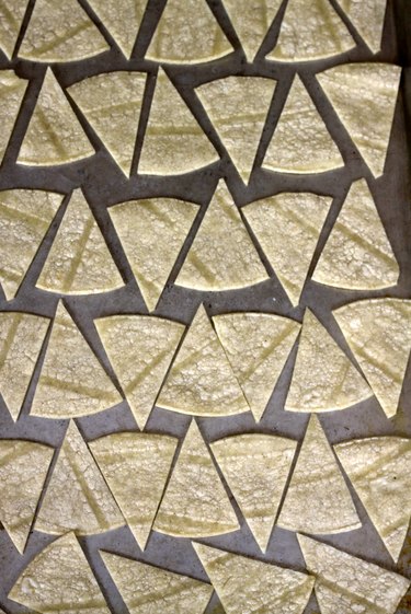 tortilla chips lined on a pan