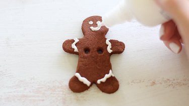 Decorating gingerbread man with puffy paint