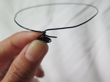 The cut wire poking out of the mouse ear.