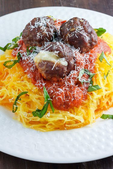 Roasted Garlic Pasta Sauce served with shredded spaghetti squash and mozzarella-stuffed meatballs