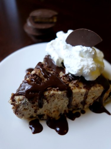 No-bake low carb peanut butter cream cheese pie with ganache, whipped cream, and peanut butter cup.
