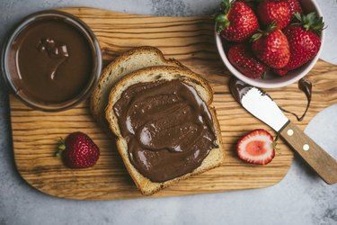 shot of homemade Nutella spread on toast and strawberries