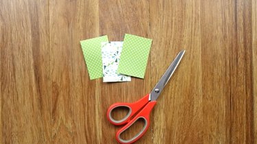 Cutting scrapbook paper to make DIY Christmas tree gift tags