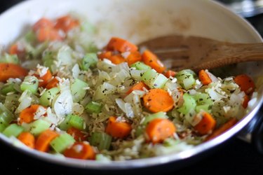Skillet with vegetables, rice, and herbs