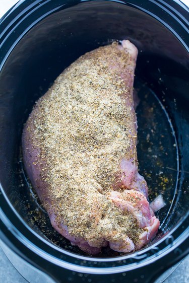 Coat the turkey breast in spices.