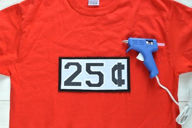 Hot glue the 25 cents sign onto the T-shirt