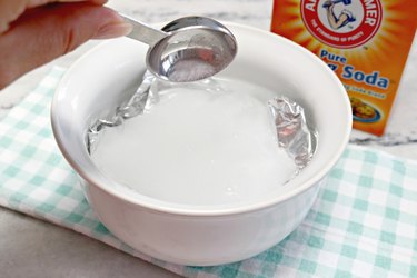 Adding baking soda to bowl