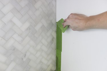 Removing tape from wall.