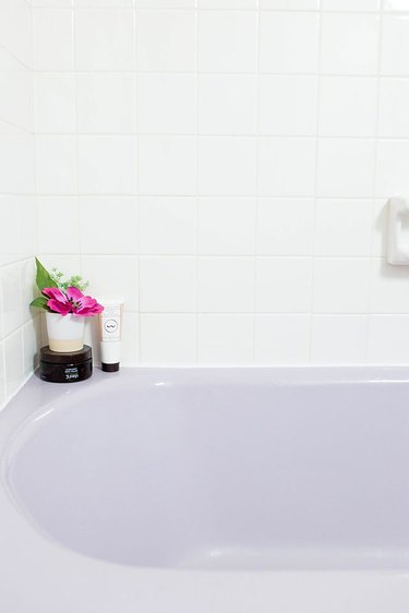 Purple bathtub with newly installed caulk