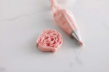 Use a petal tip to pipe a buttercream rose.