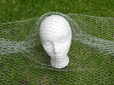 Chicken wire bunched at the ears of the foam head.
