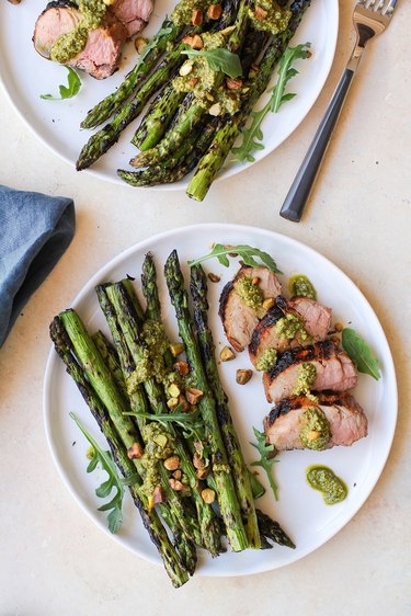 grilled pork tenderloin on a plate with asparagus