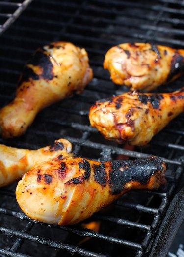 Drumsticks with grill marks on a grill