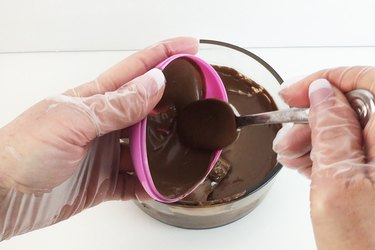 Coat the interior of the plastic eggs with chocolate