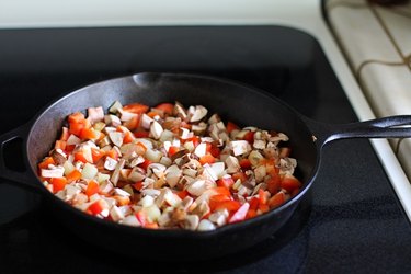 Onion, bell pepper, and mushrooms in a skillet